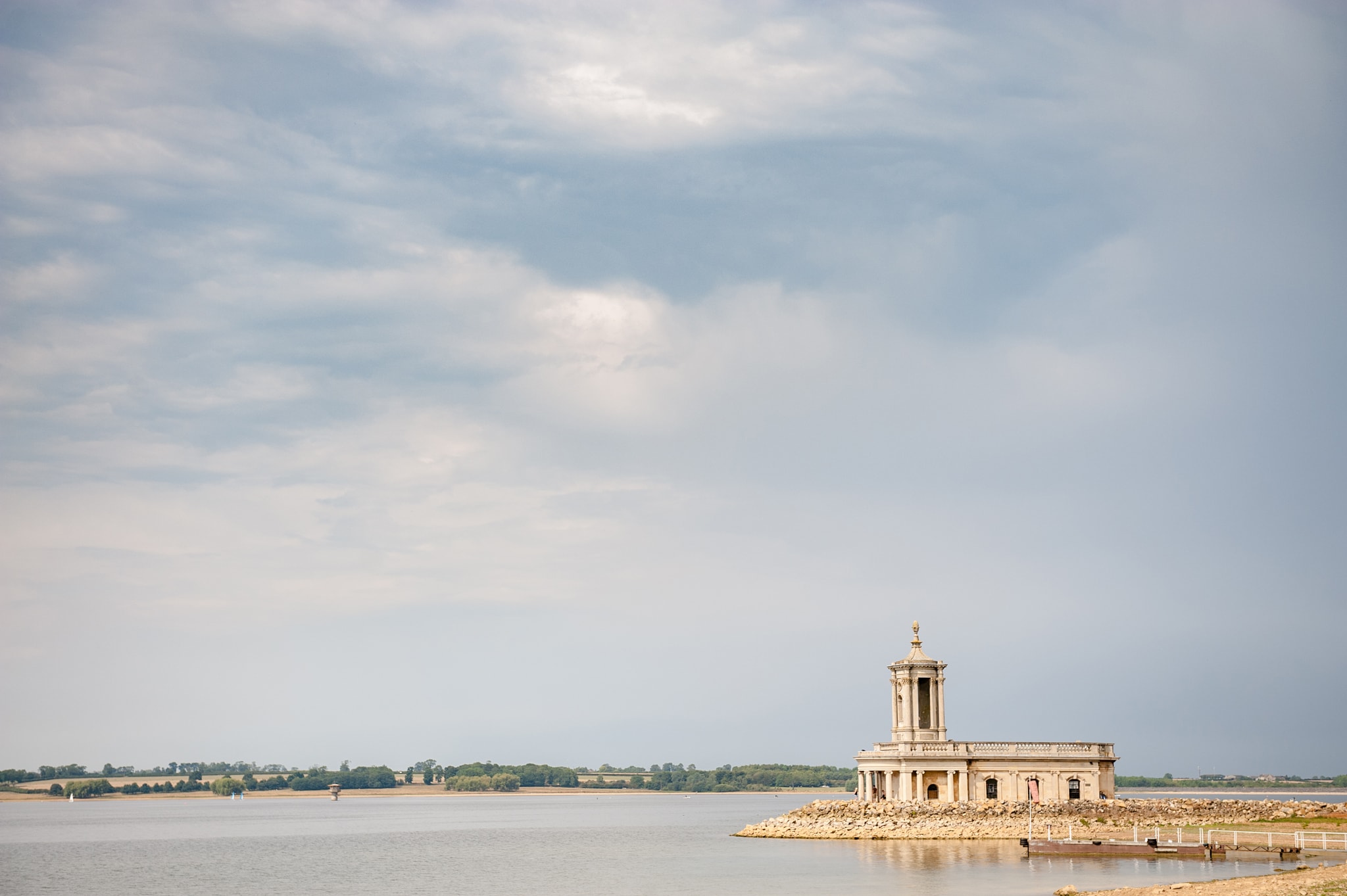 View of Normanton church and Rutland water on a cloudy day