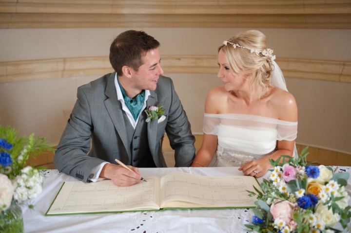 Bride and groom signing the register at Normanton church