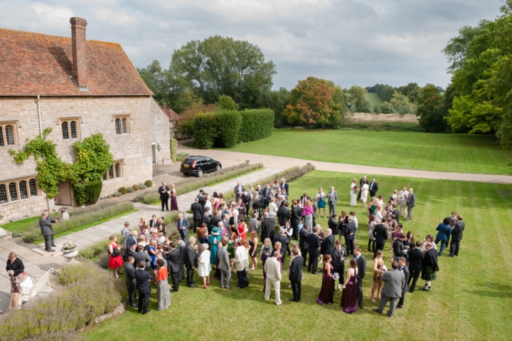 View from an upstairs window of guests on the lawn at Notley Abbey during the drinks reception