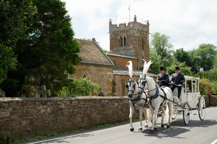 A wedding horse and carriage outside Rushton church