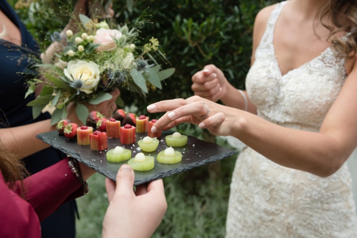 Bride's handing taking a canape