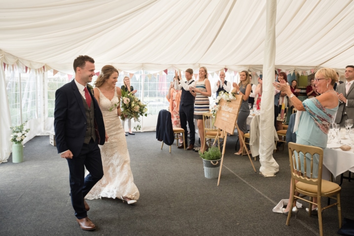 Bride and groom entering the marquee at The William Cecil in Stamford