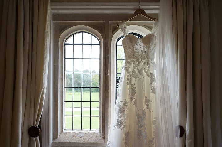 Wedding dress hanging in a window at Notley Abbey