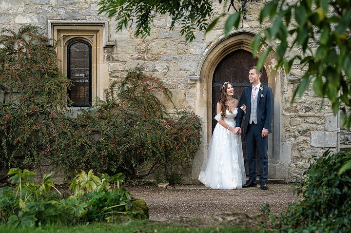 Bride and groom at the back door to Notley Abbey