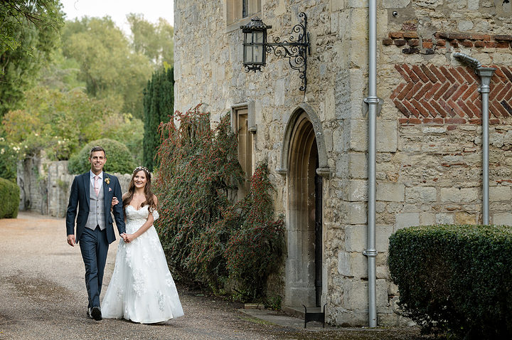 Bride and groom walking in the grounds of Notley Abbey