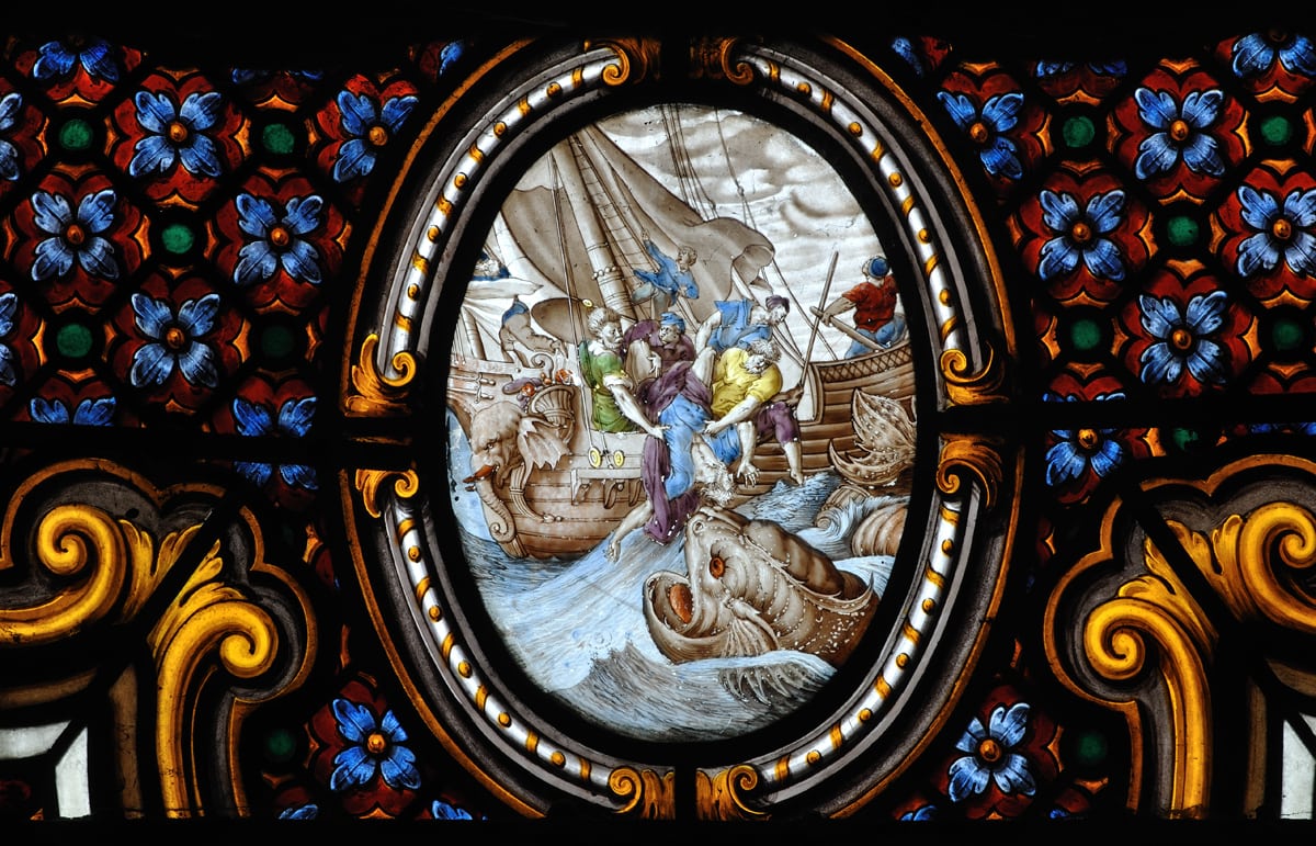 Scene of Jonah and the whale in a church stained glass window