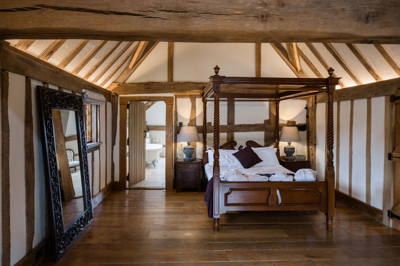 The wedding suite at Cain Manor with a four-poster bed and large floor standing mirror