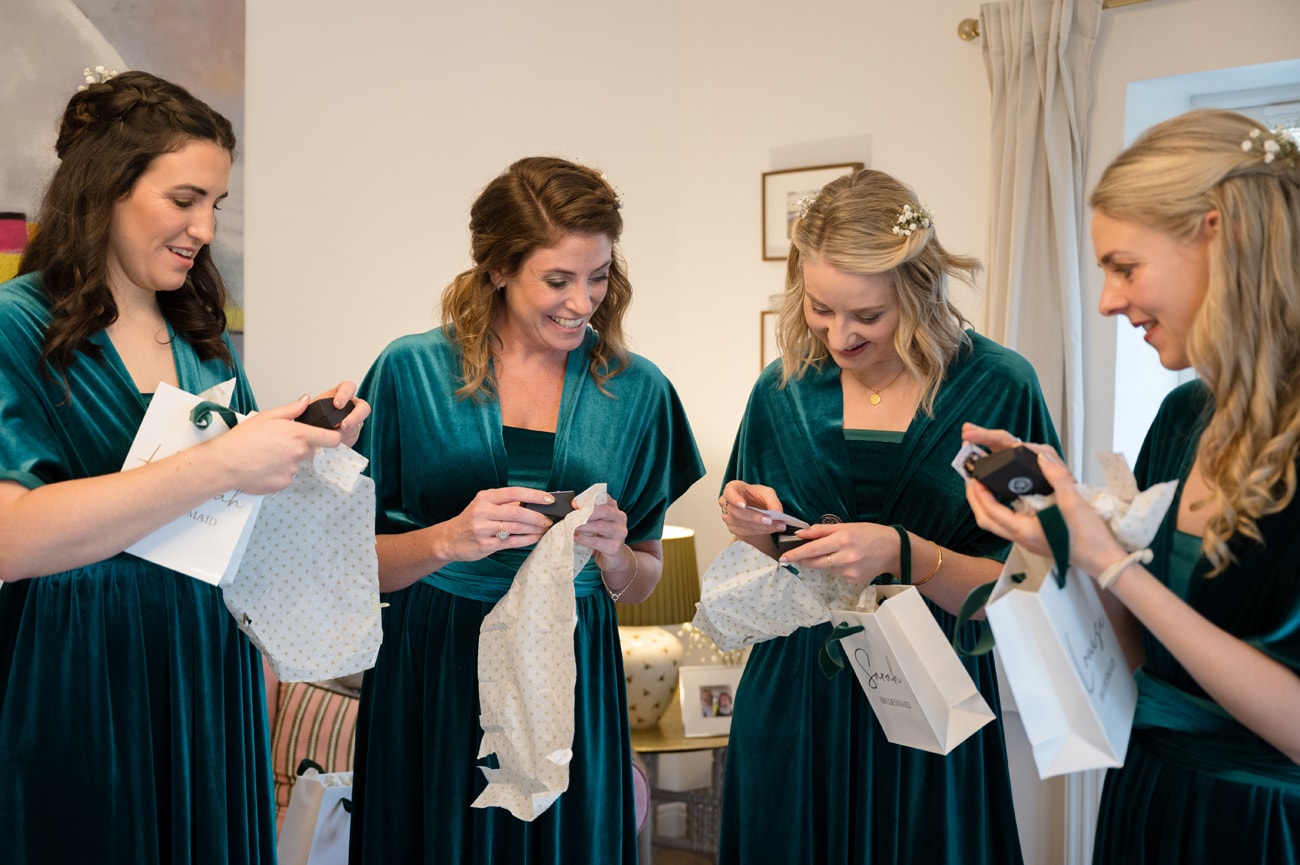 Bridesmaids opening wedding gifts from the bride