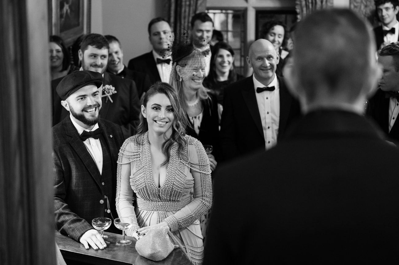 Wedding guests laughing at the best man's speech
