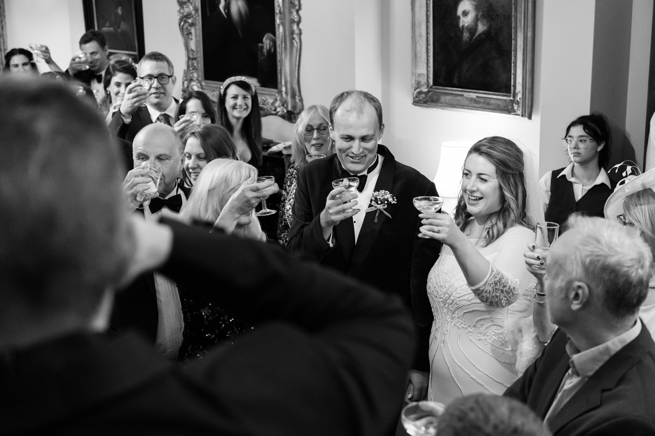 Bride and groom and their guests toasting the best man's speech at Plum Park Manor