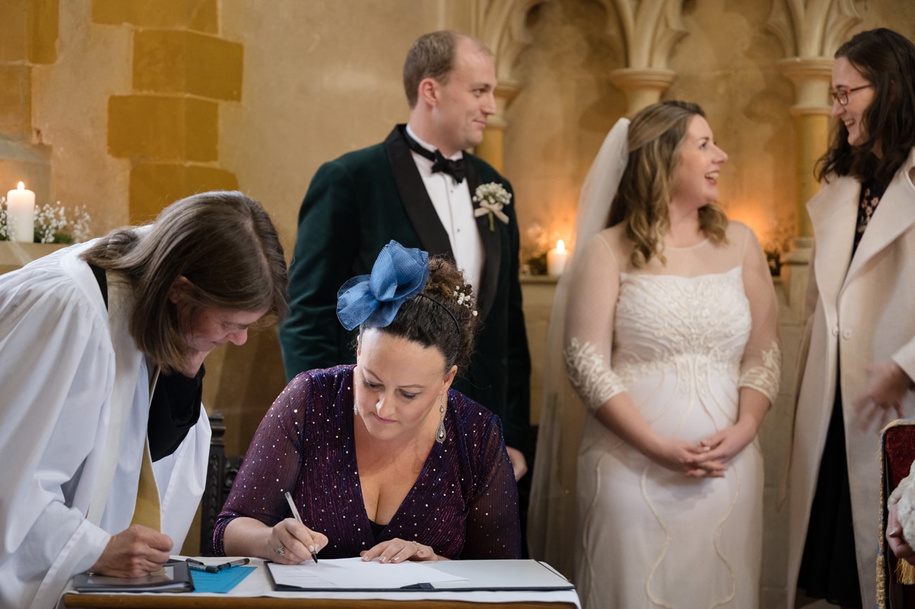 Witness signing the marriage register at St Michael's church in Silverstone