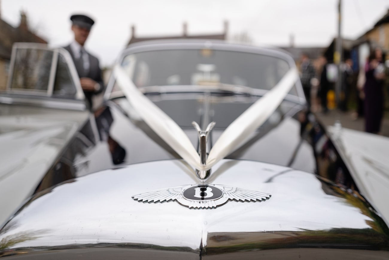 Detail photo of the Bentley badge on a vintage wedding car