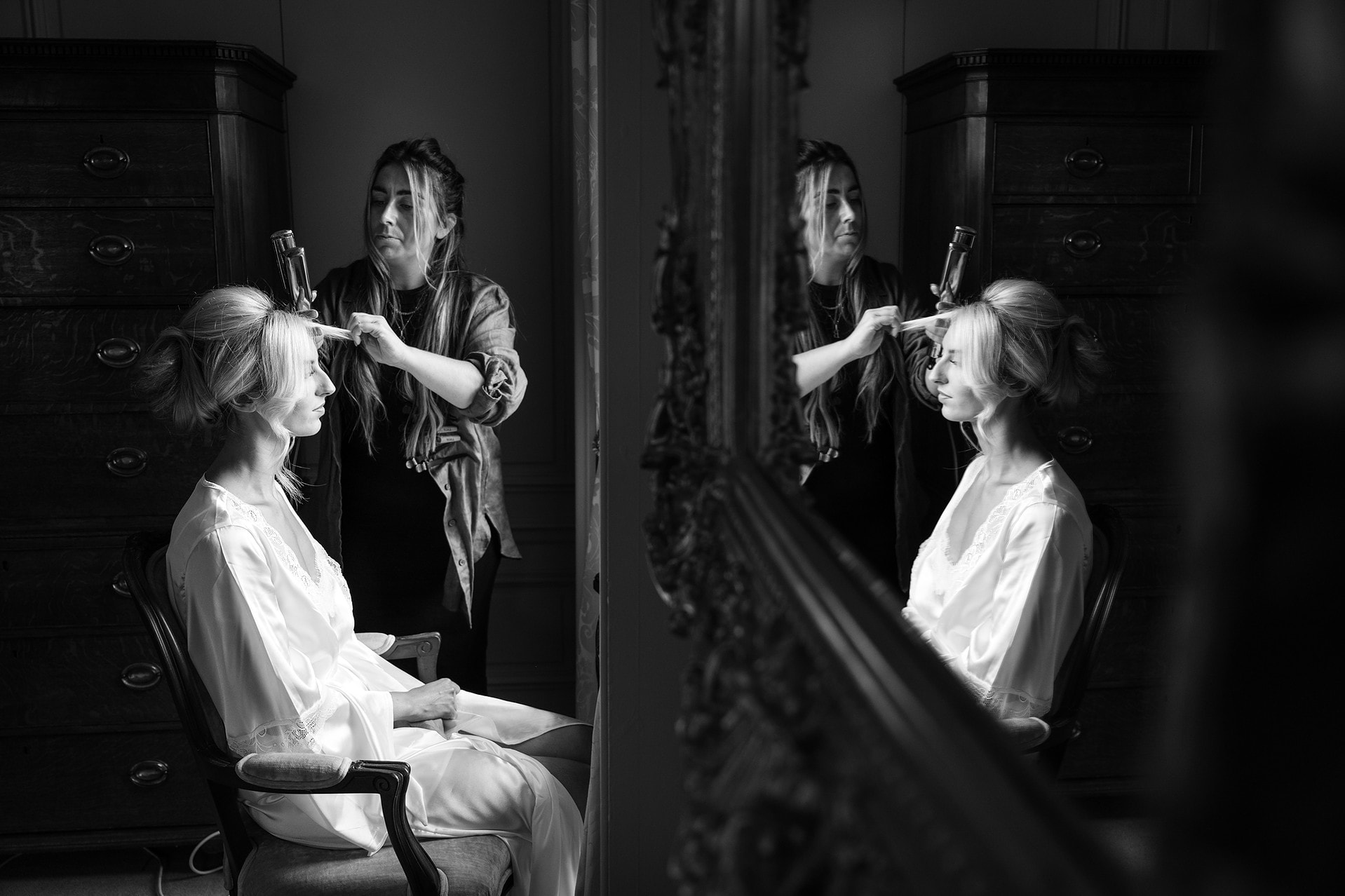Mirror reflection of bride having her hair done