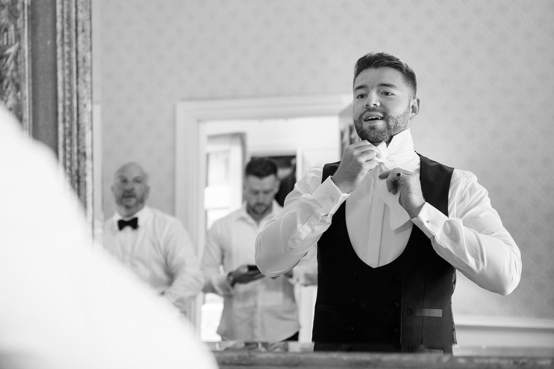 Groom tying a real bow tie