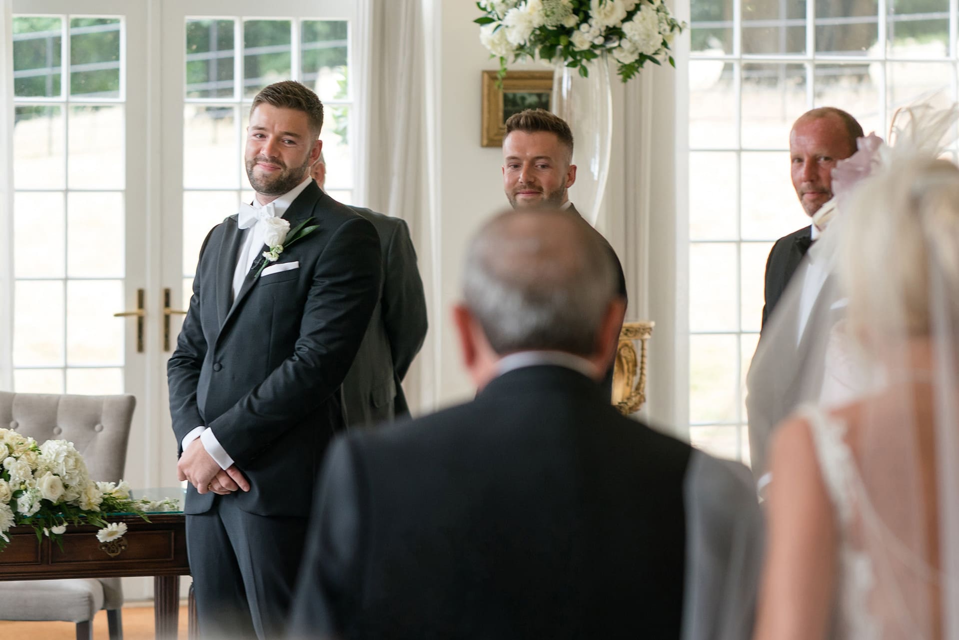 Groom's reaction as he watches bride walk down the aisle