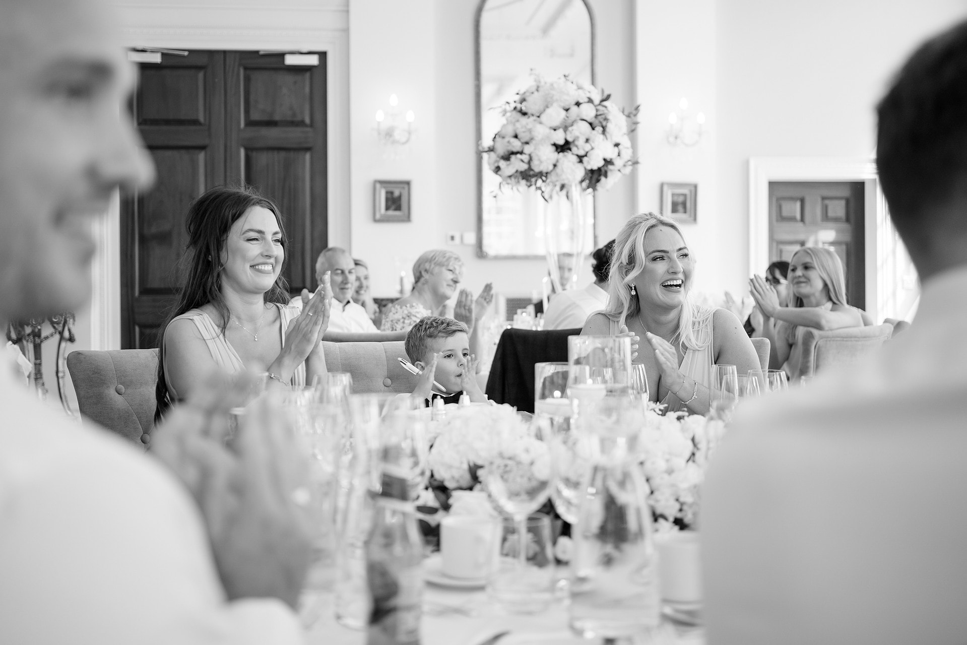 Bridesmaids and pageboy clapping during speeches