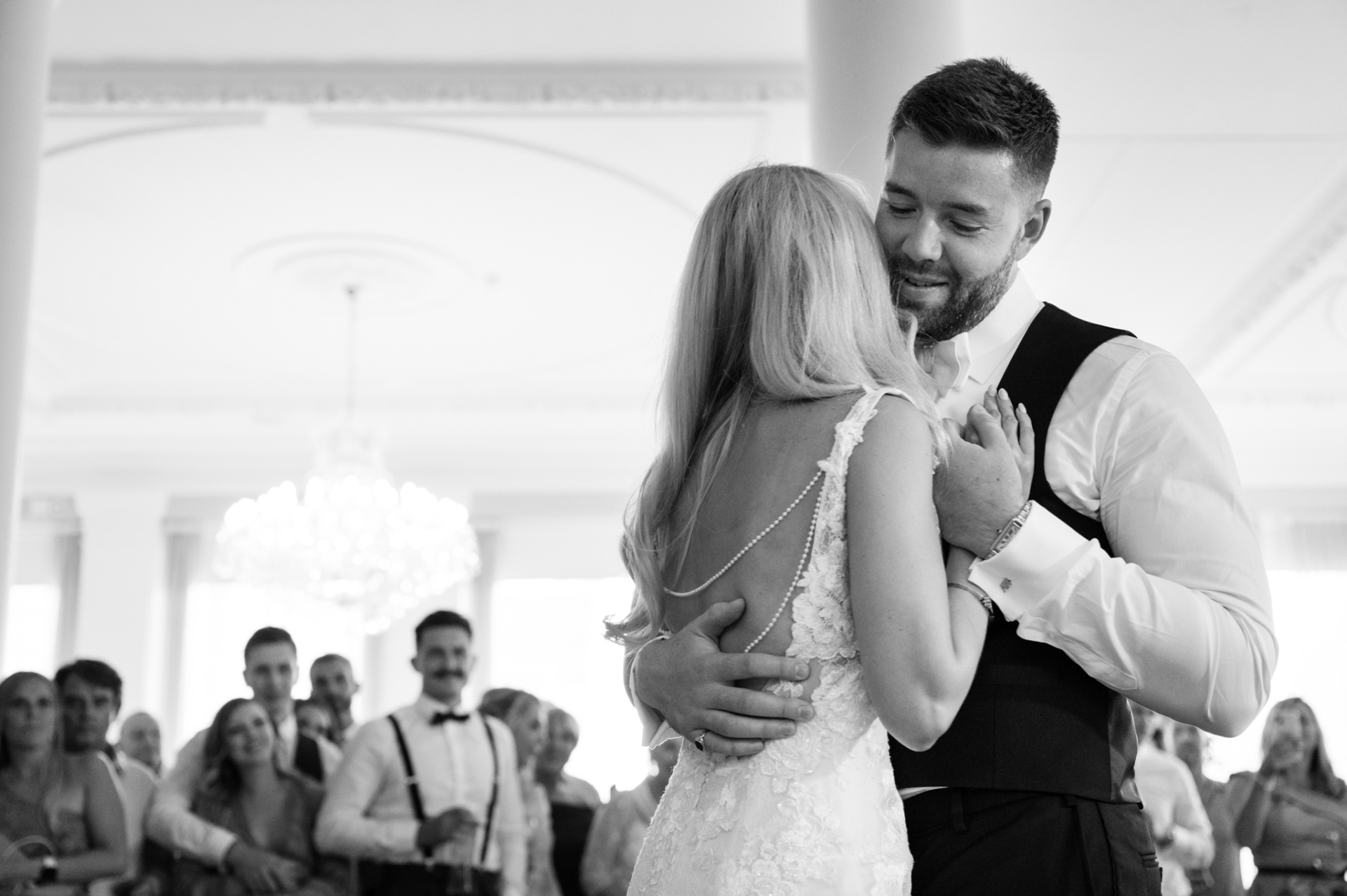 Groom looking dreamily at bride during first dance