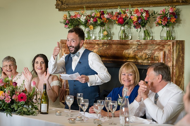 Groom making a thumbs-up gesture during his speech