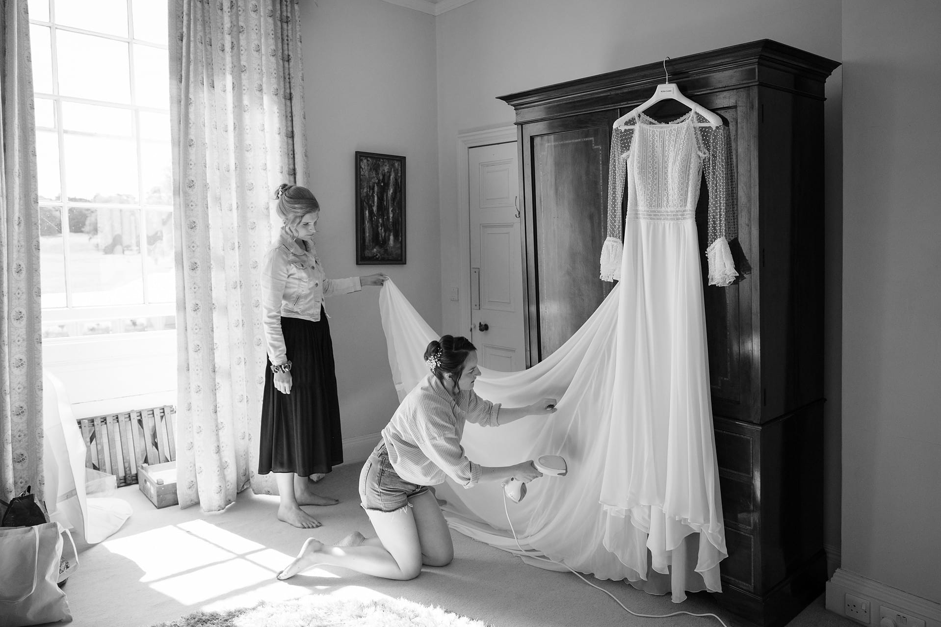 Bridesmaids steaming the bride's dress