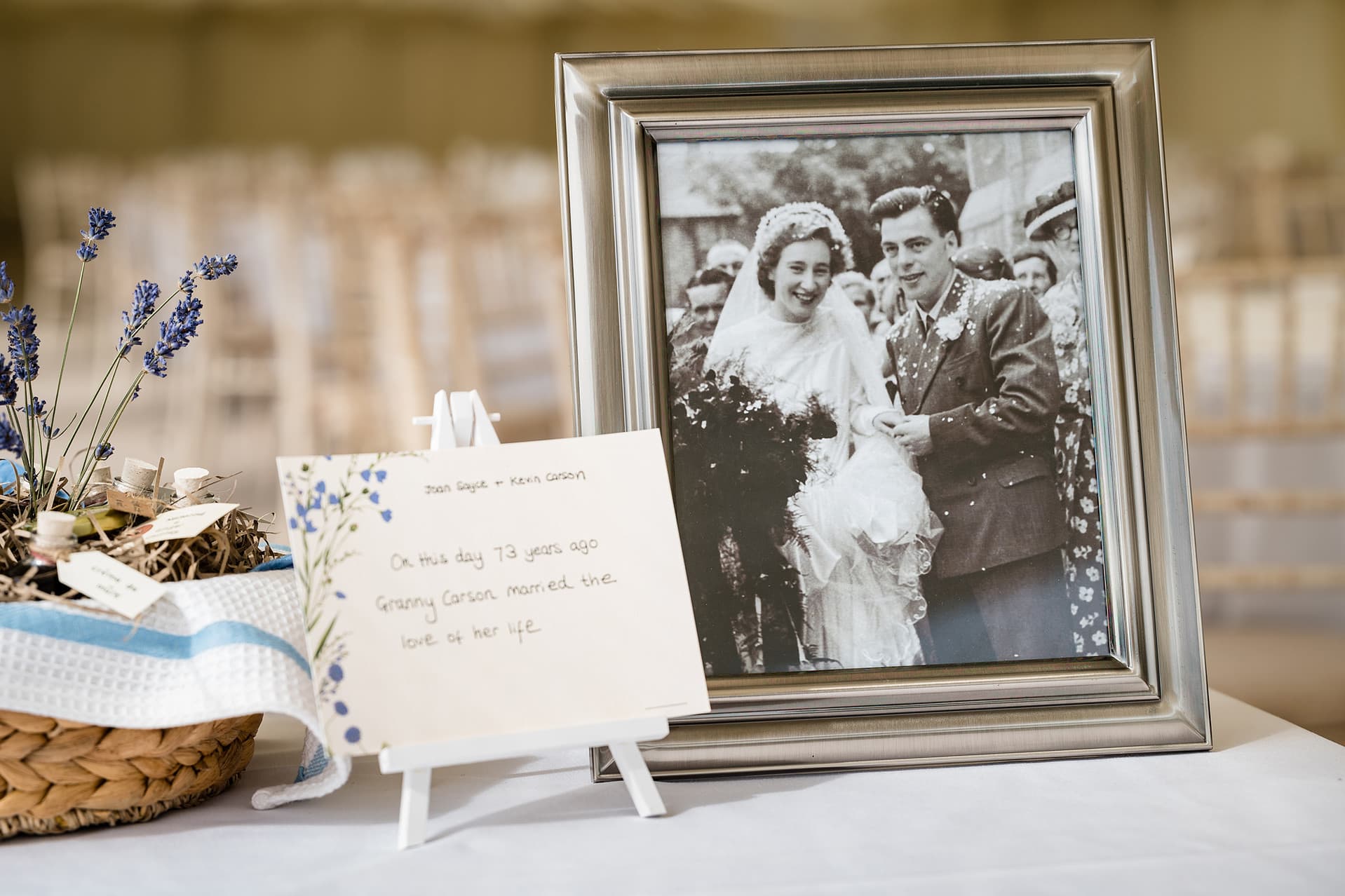 Black and white framed photo of the bride's grandparents and a sign that says they married on the same date