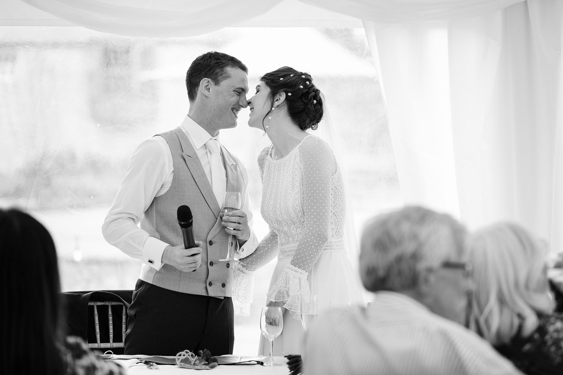 Bride and groom doing eskimo kisses during their joint wedding speech