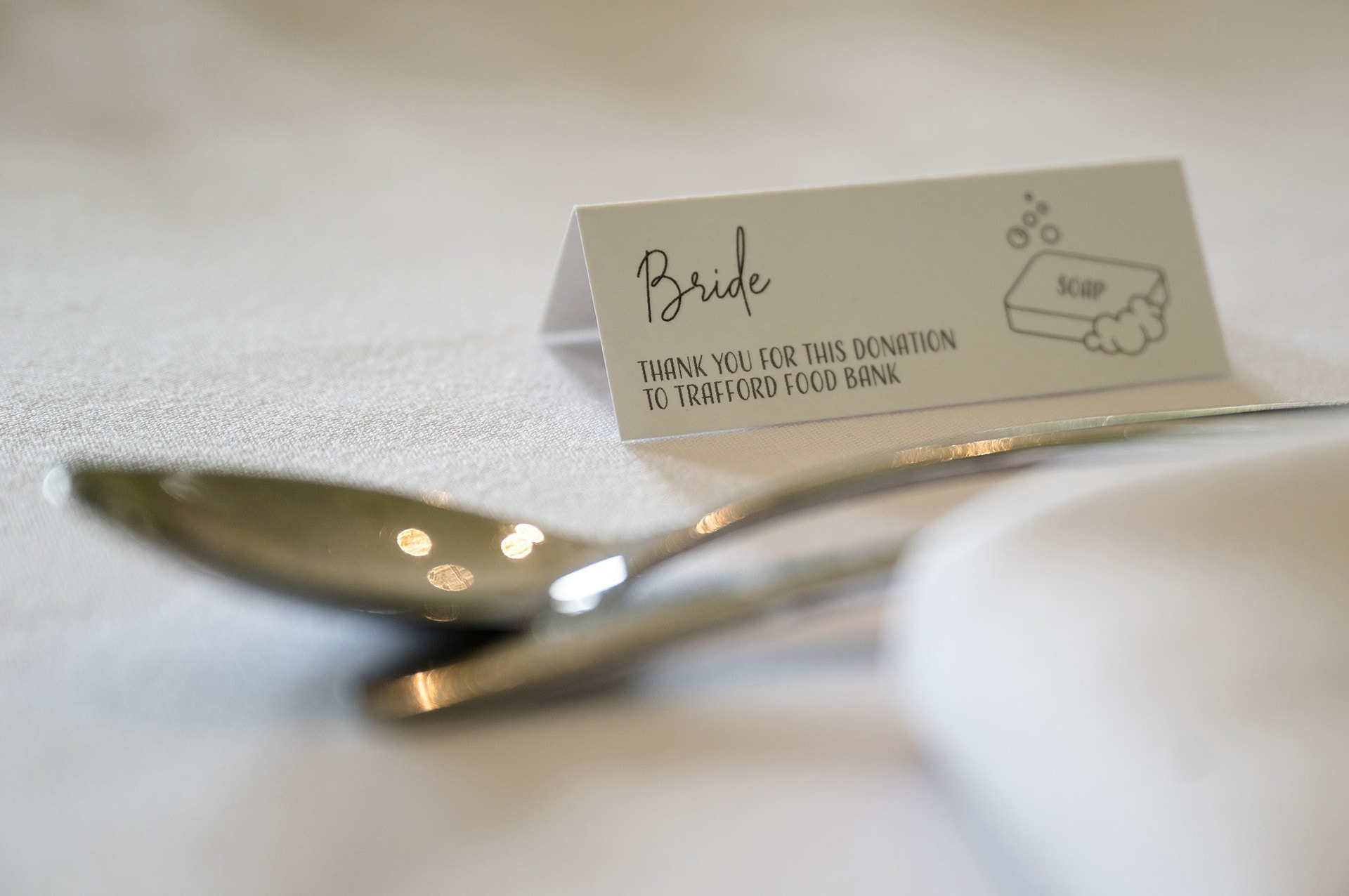 Wedding placecard showing a donation has been made to a foodbank instead of giving favours to guests