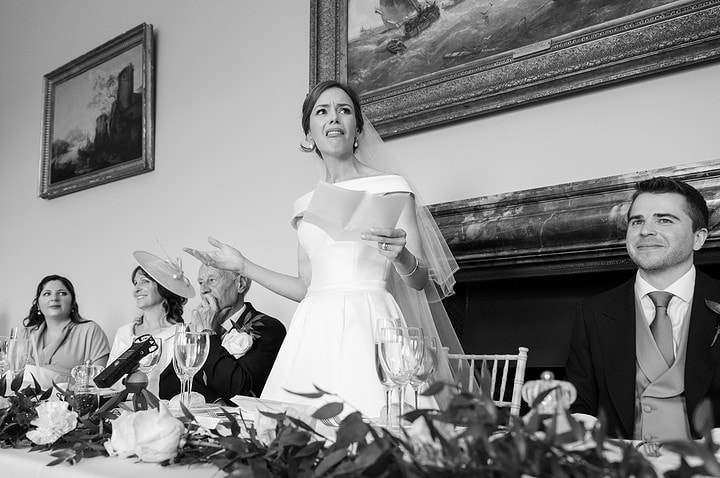 The bride with a quizzical expression as she makes her speech