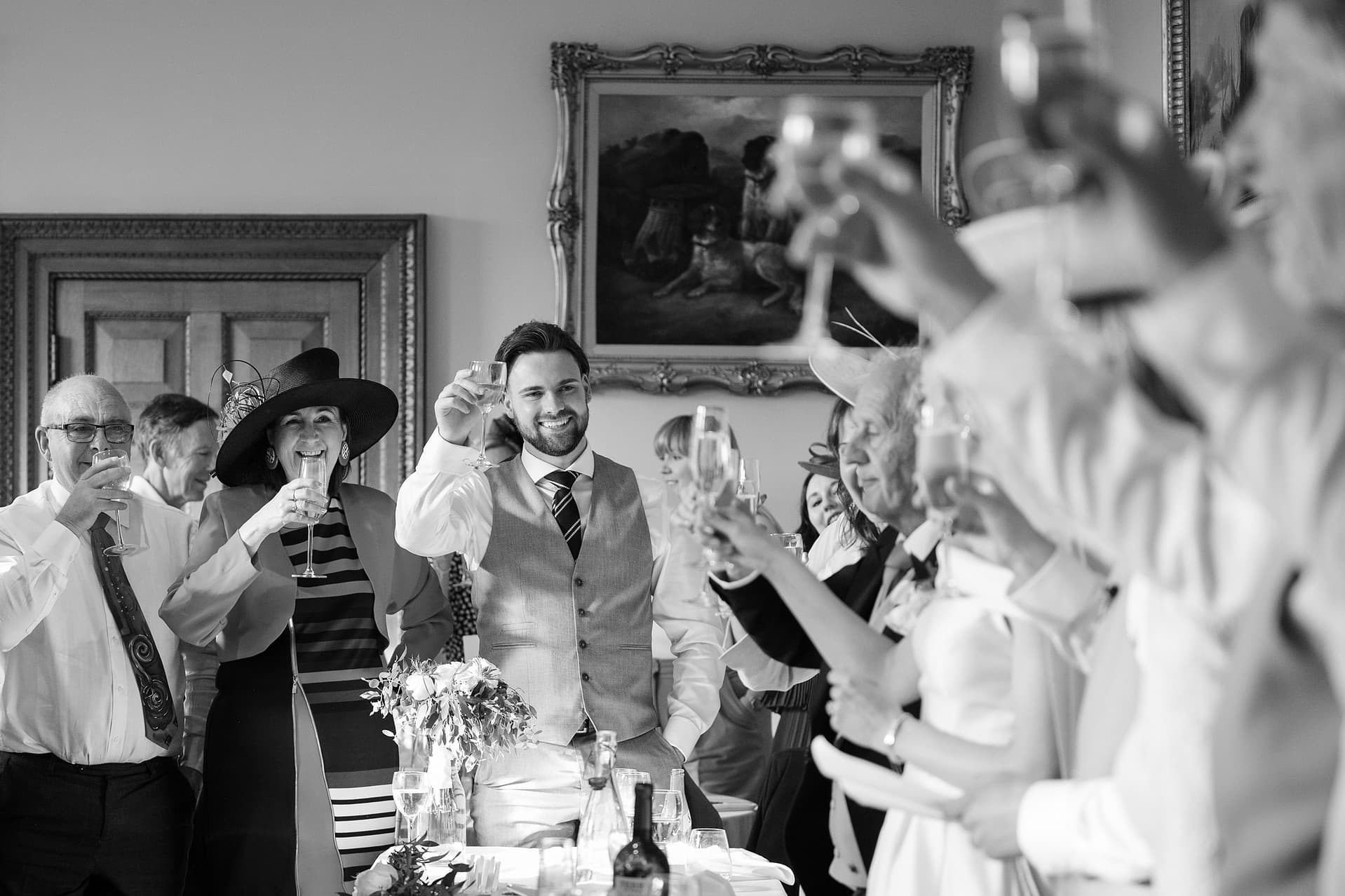Wedding guests raising their glasses for a toast during the speeches