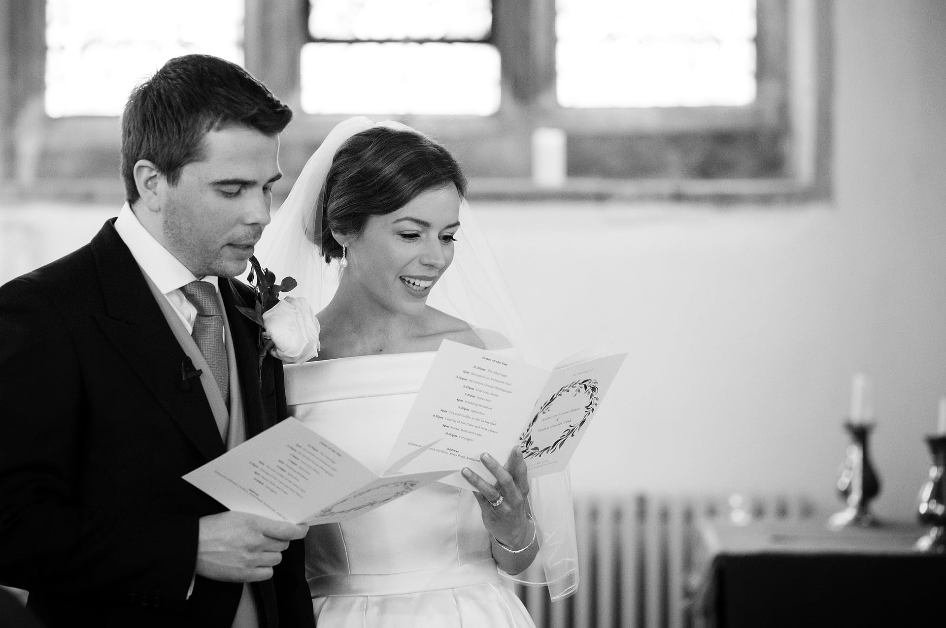 Bride and groom singing a hymn at St Catherine's church in Houghton on the Hill