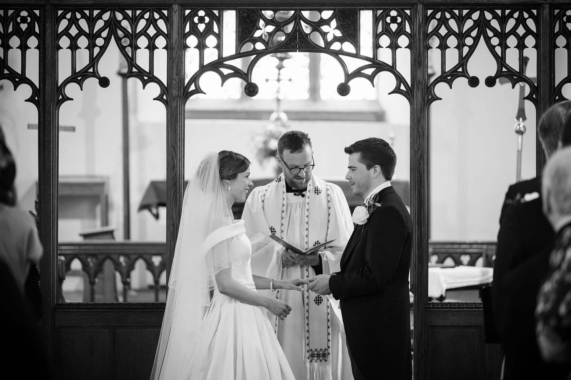 Bride and groom saying their marriage vows at St Catherine's church in Houghton on the Hill