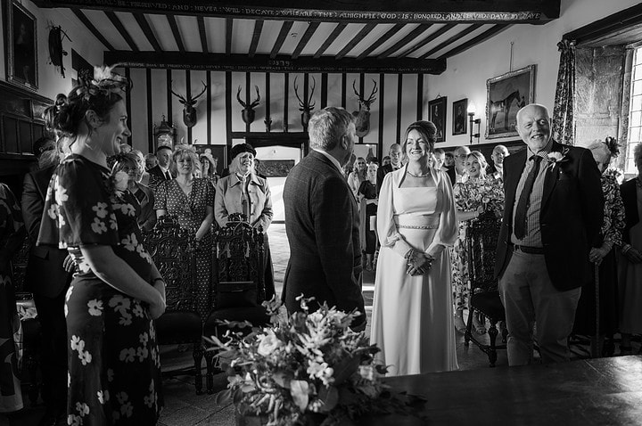 Everyone standing up at the beginning a wedding ceremony at Rockingham Castle