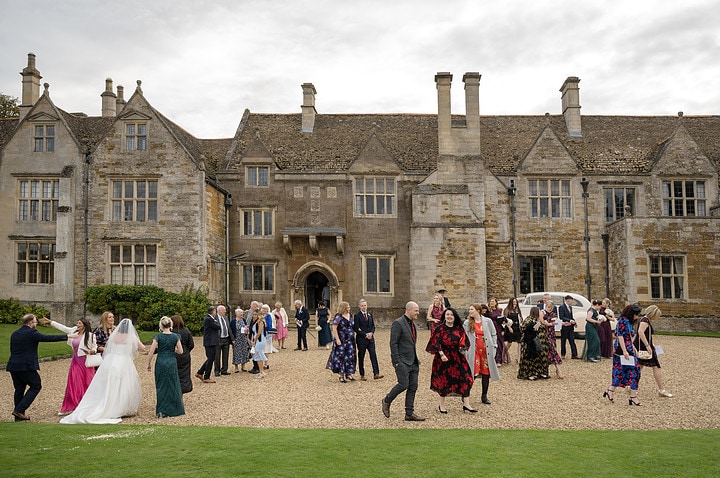 Wedding guests coming out of Rockingham Castle after the ceremony