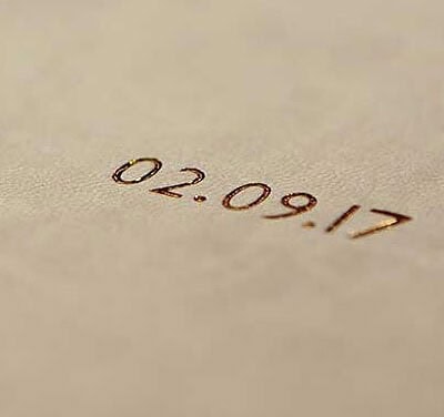 Close up of a gold foil title on the front cover of a wedding album