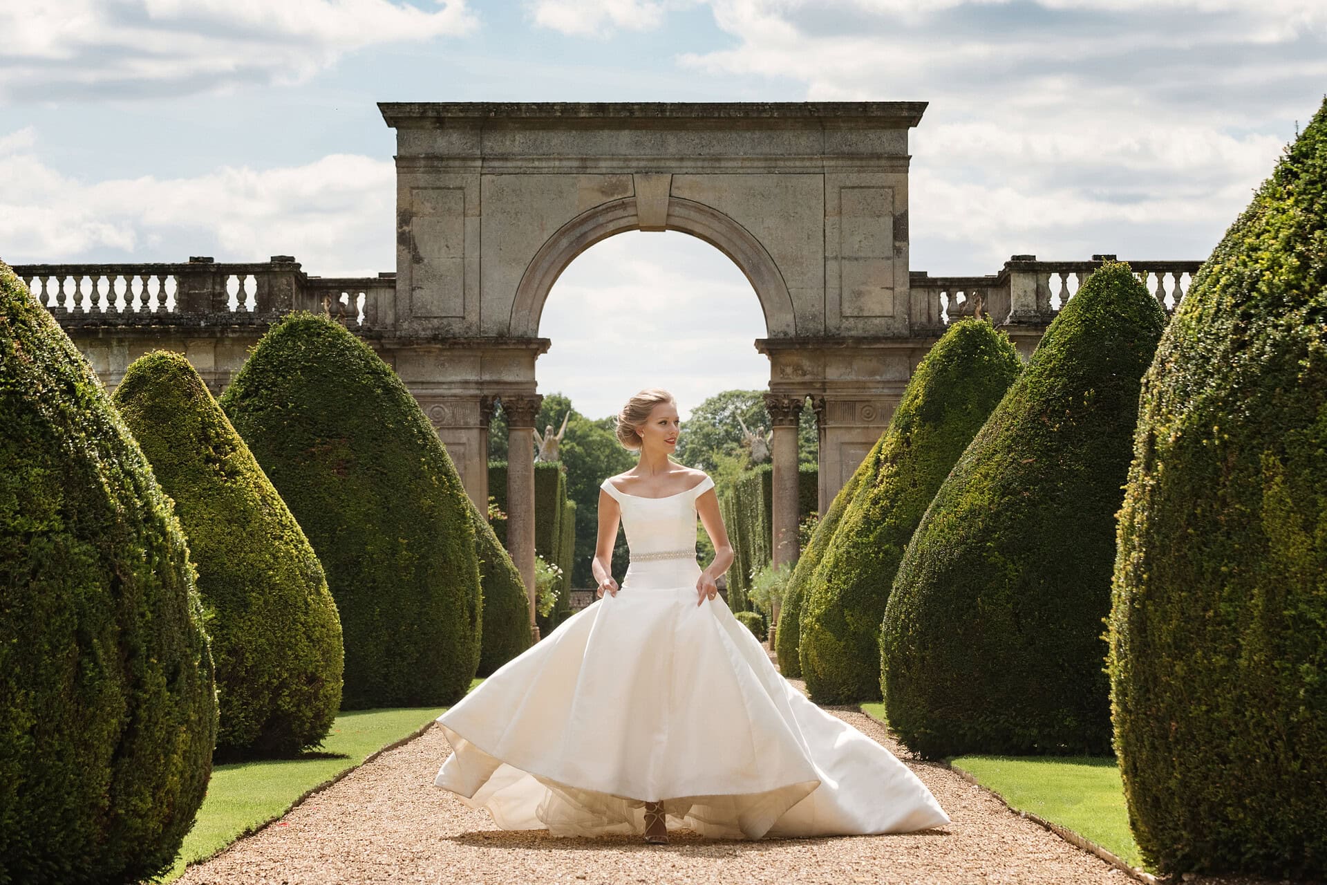 Bride in front of Triumphal Arch at Castle Ashby Gardens