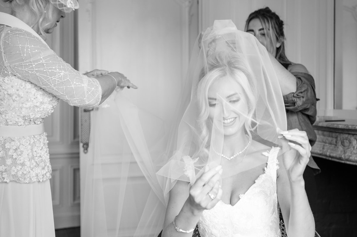 Two ladies fitting the bride's veil