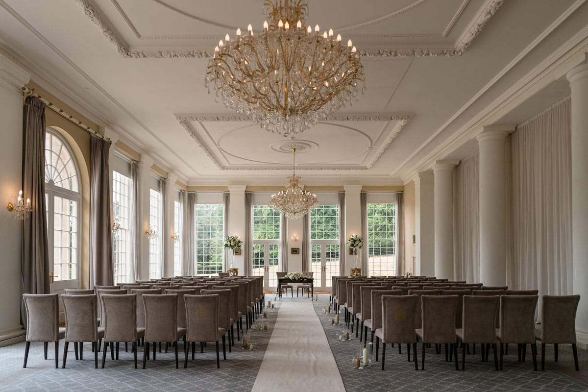 Grand ballroom with large chandeliers set for a civil wedding ceremony