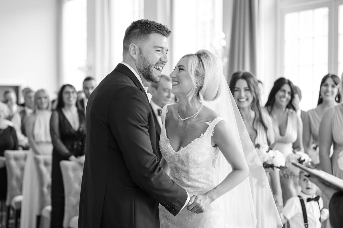 Bride and groom laughing during their wedding ceremony