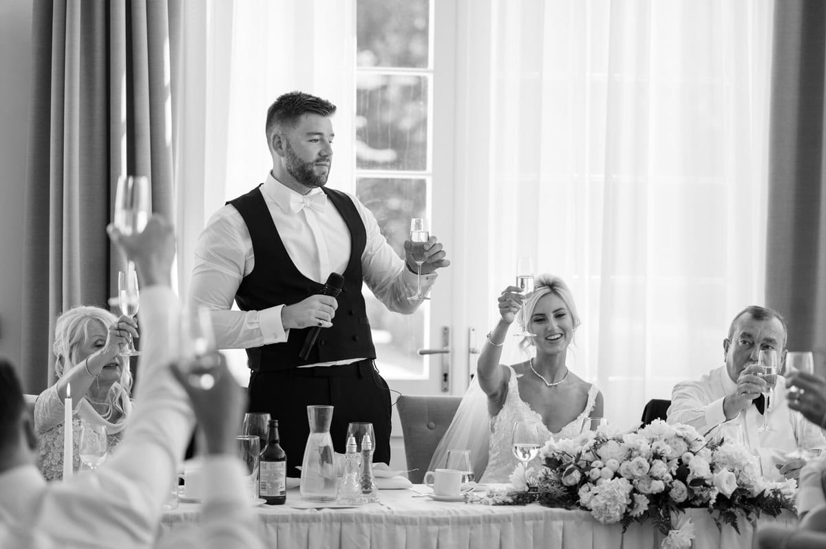 Groom raising a toast during wedding speech