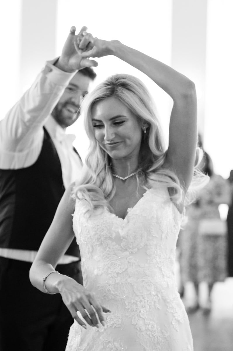 Groom twirling the bride during their first dance