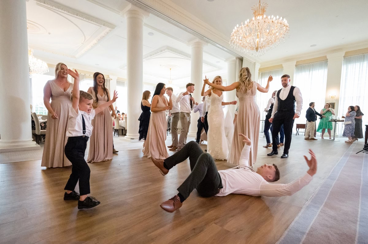 Wedding dance floor with lively guests celebrating at a luxurious venue